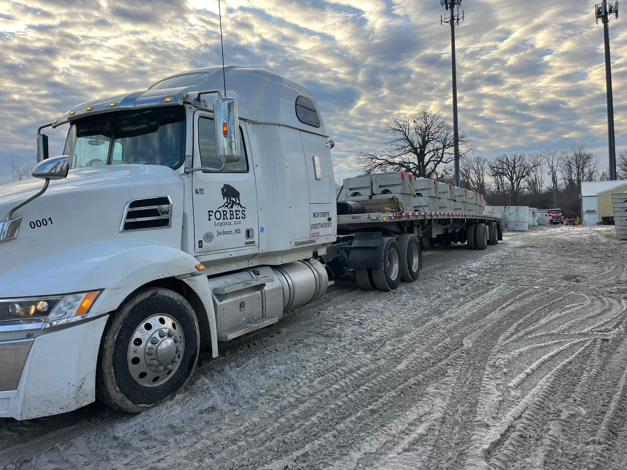 Forbes Logistix flatbed hauling precast concrete products at customer site